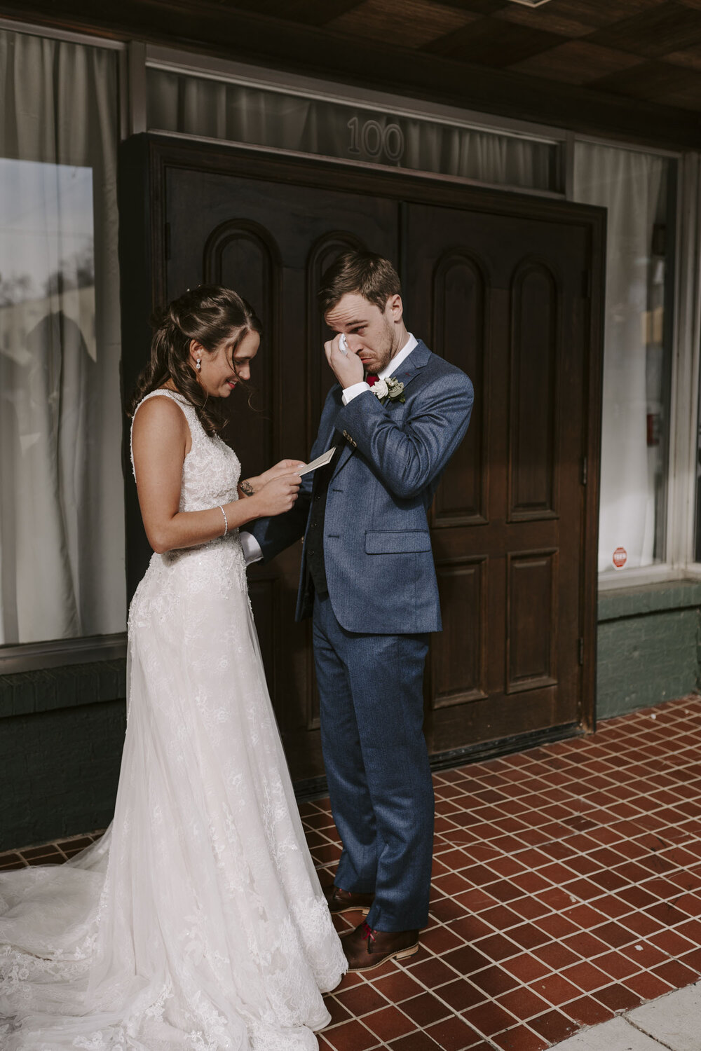 bride and groom exchanging letters during their first look