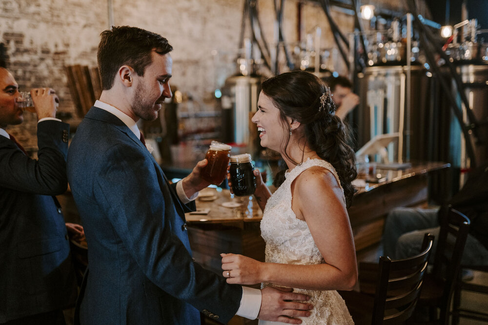 Bride and groom getting drinks at local brewery in Madison, NC