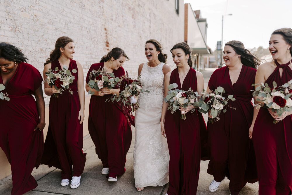 bride laughing with bridesmaids at rustic fall wedding in Winston-Salem, NC