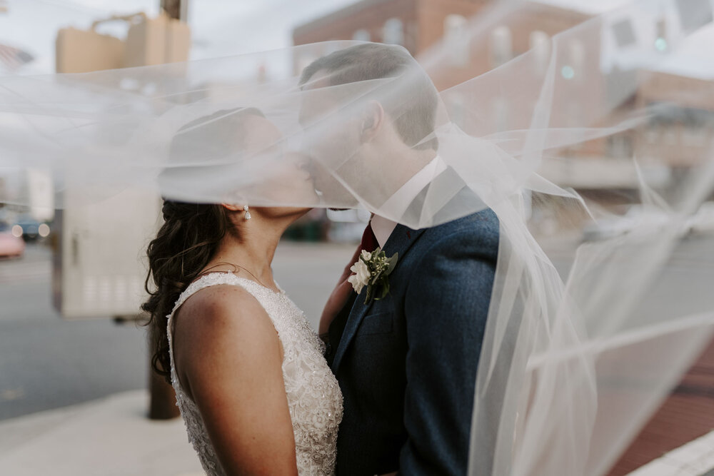 bride and groom kissing under veil at fall wedding in Winston-Salem NC