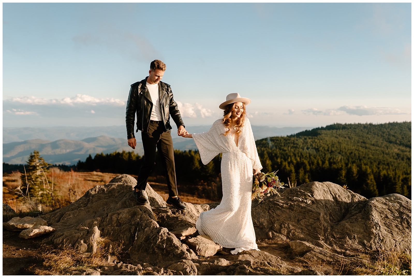 bride leads groom by the hand across NC moutaintops during elopement session