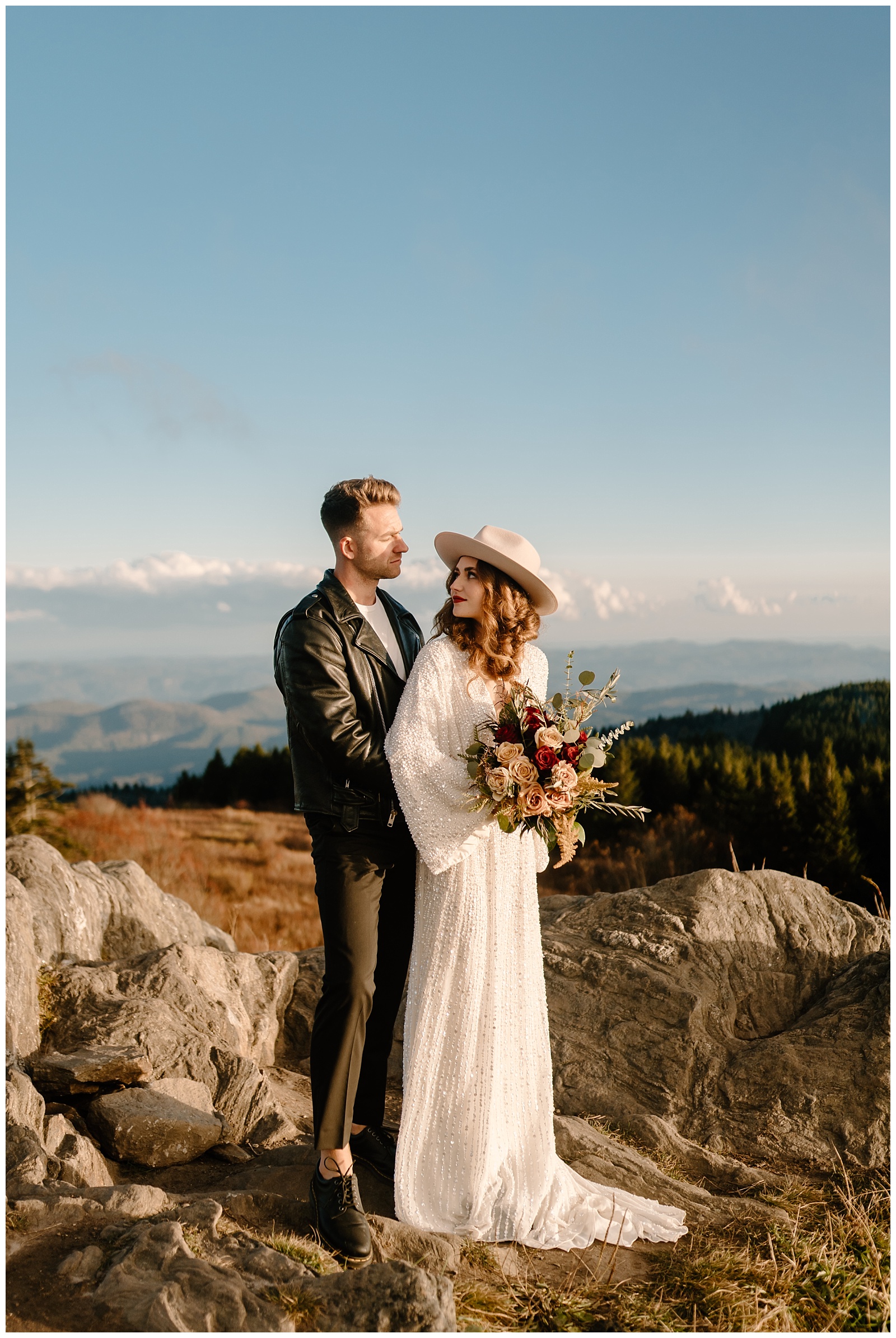 bride looks back at groom with serious face, serious boho wedding session
