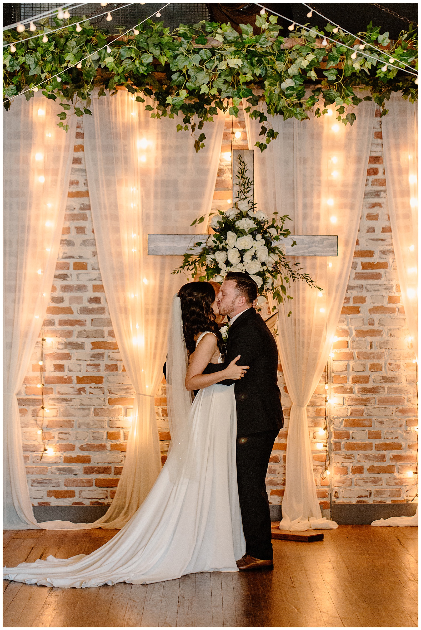 Bride and groom's first kiss as husband and wife, their modern Winston-Salem summer wedding