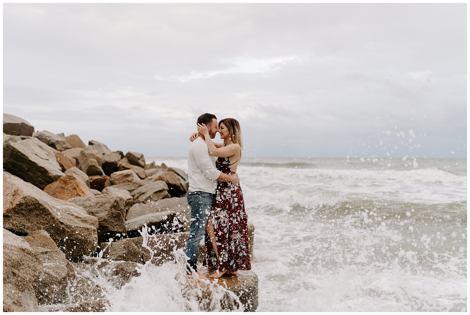 A fun and adventurous beach engagement session with crashing waves