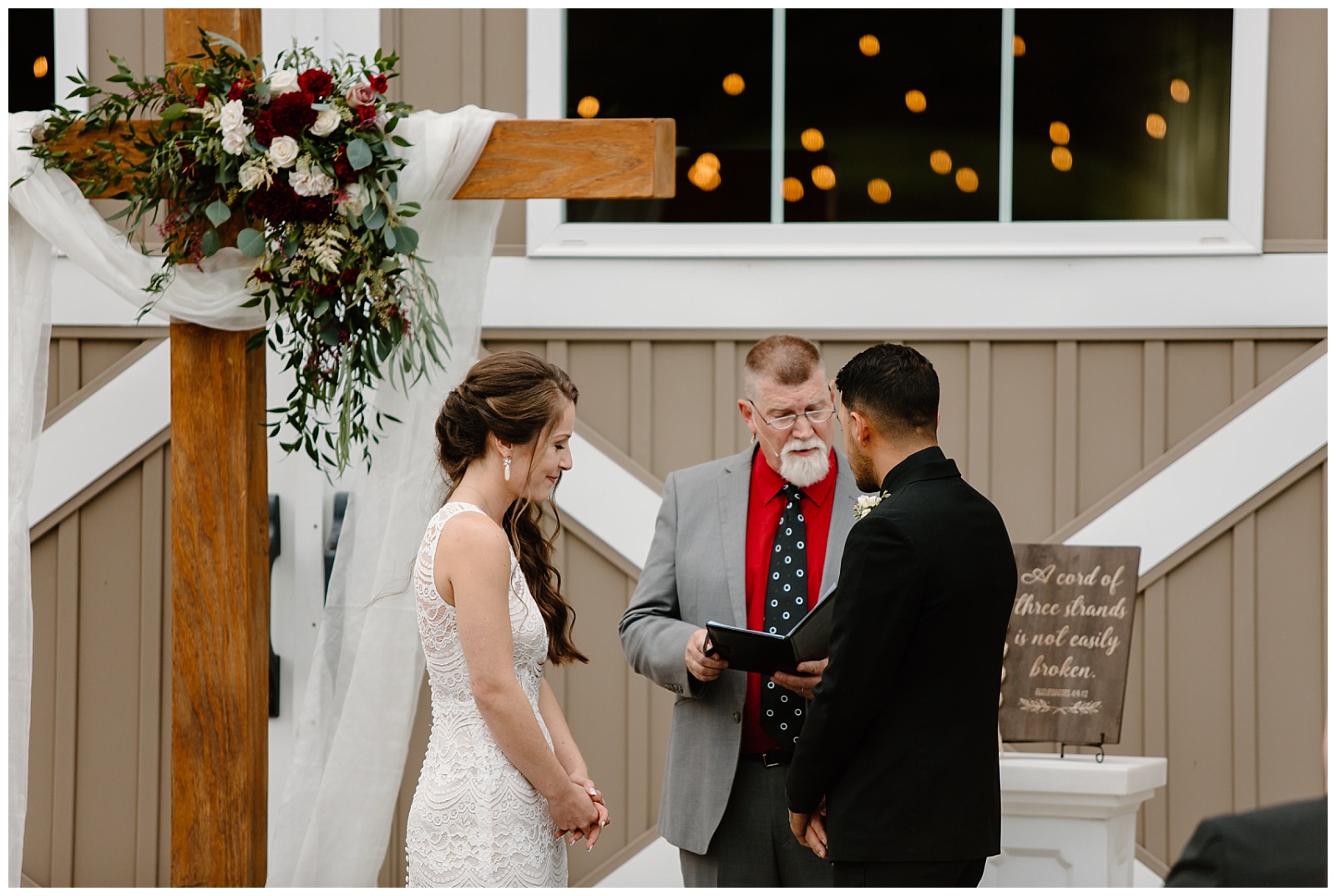 Pastor speaks and holds Bible during wedding ceremony