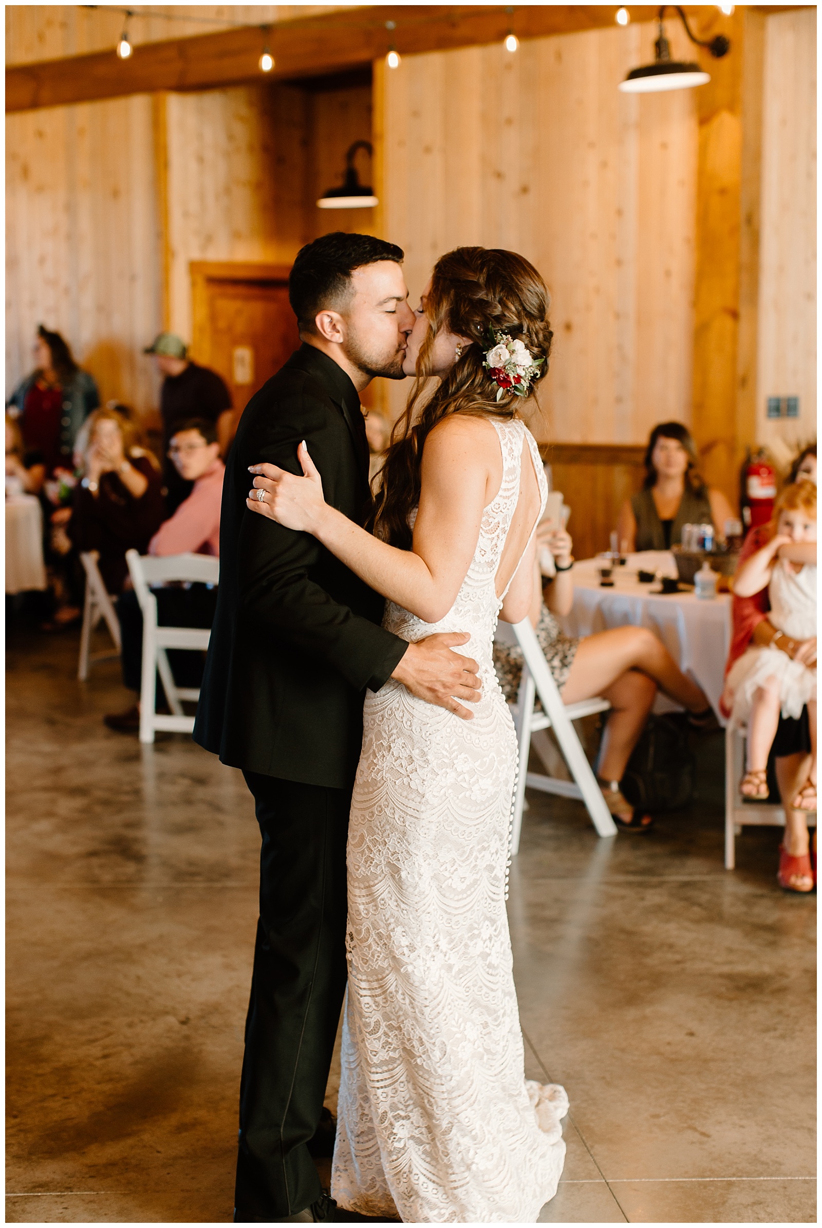 Bride and groom kiss to conclude their first dance