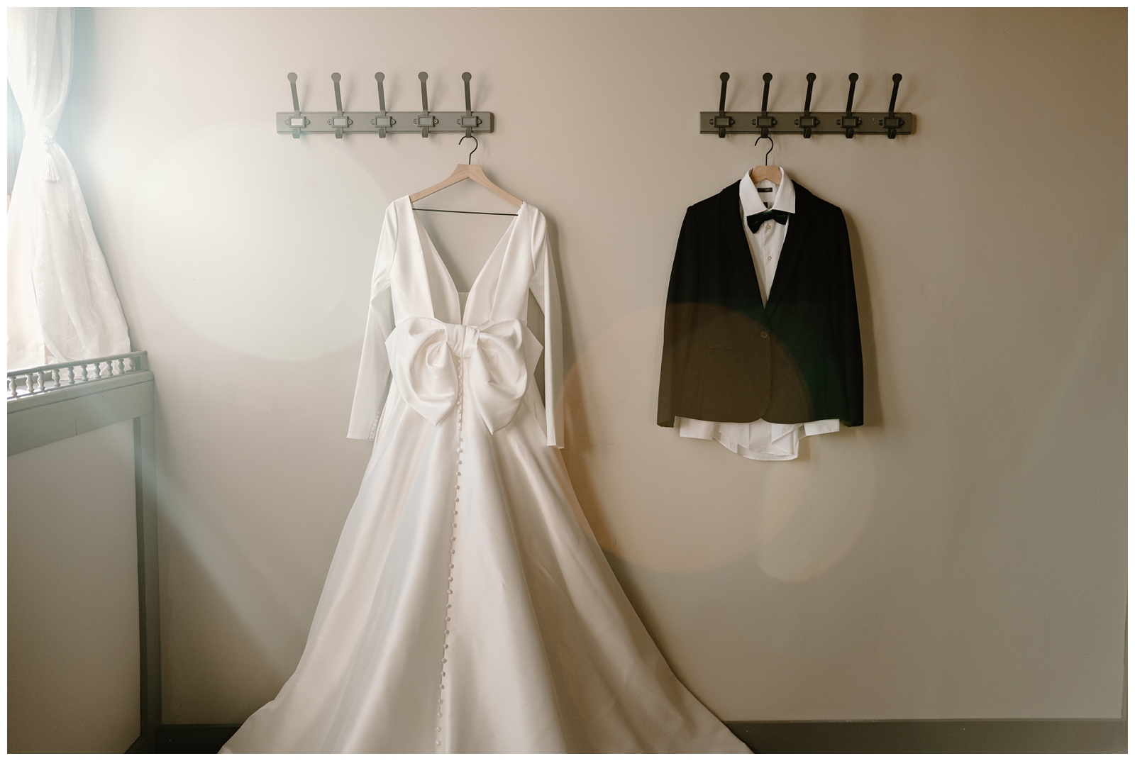 Hanging wedding dress and tux at this North Carolina same-sex elopement
