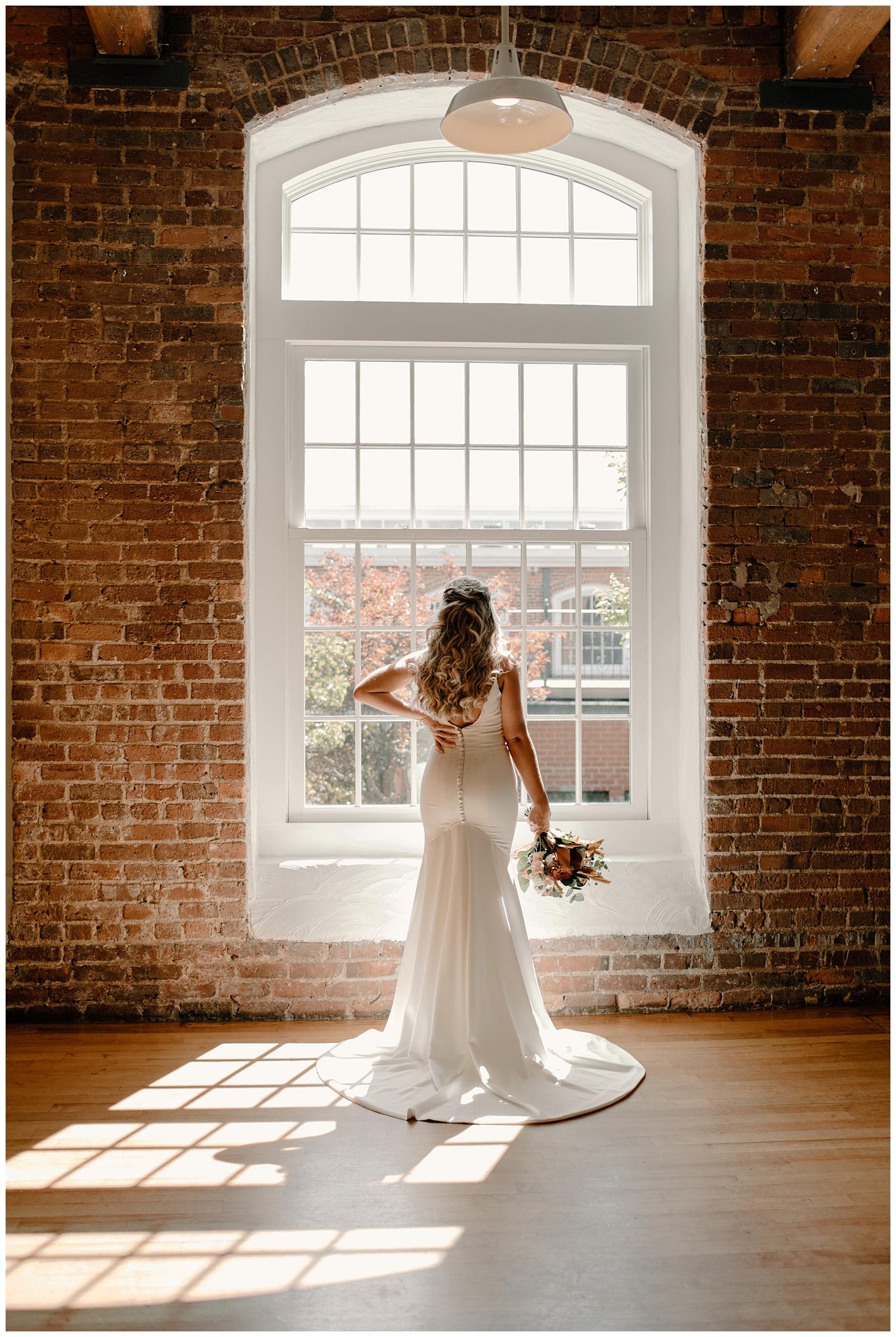 Dramatic bridal portrait of fall bride at Greensboro NC's historical venue Revolution Mill