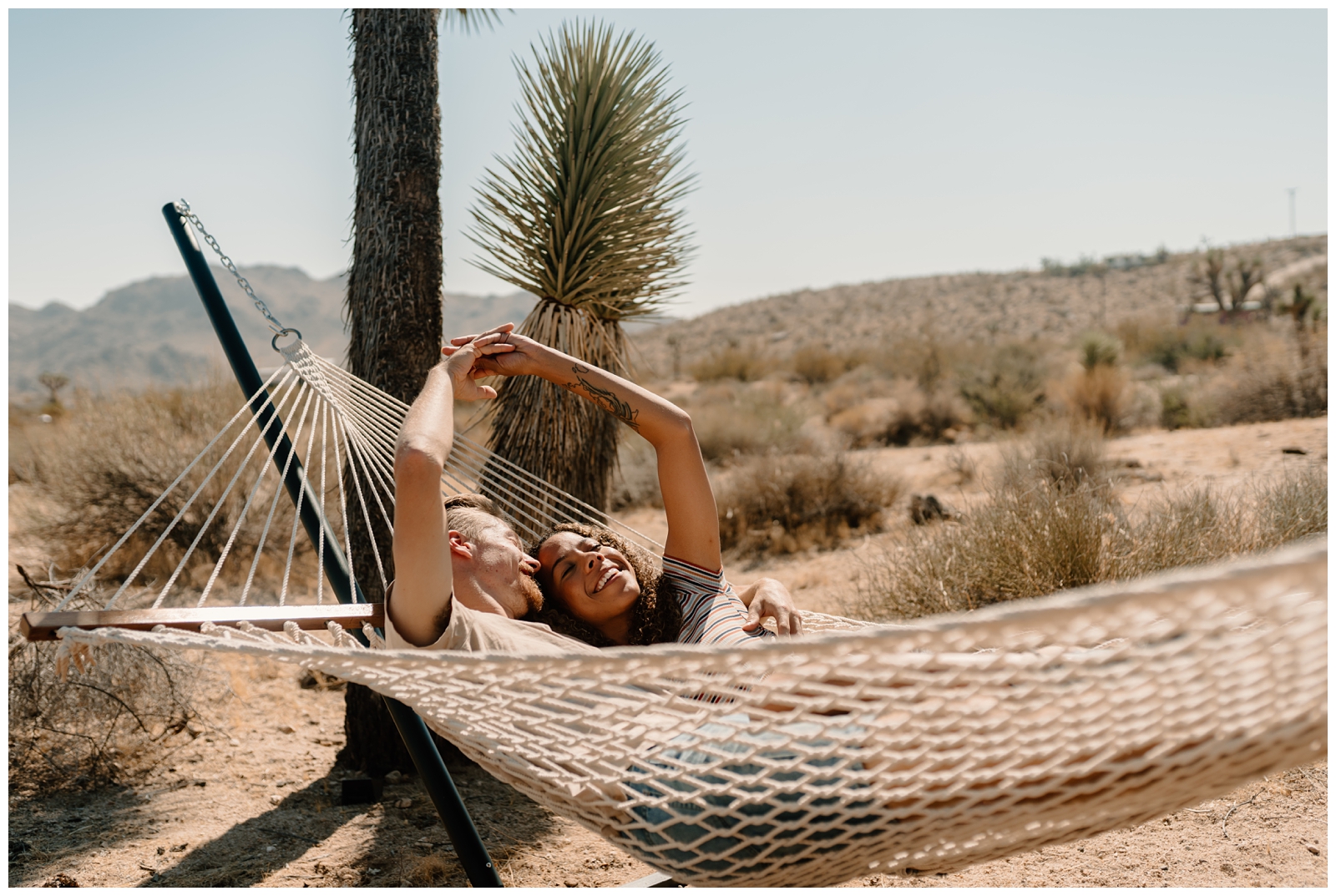 Cosy Joshua Tree couple's session at their airbnb campsite by destination wedding photographer