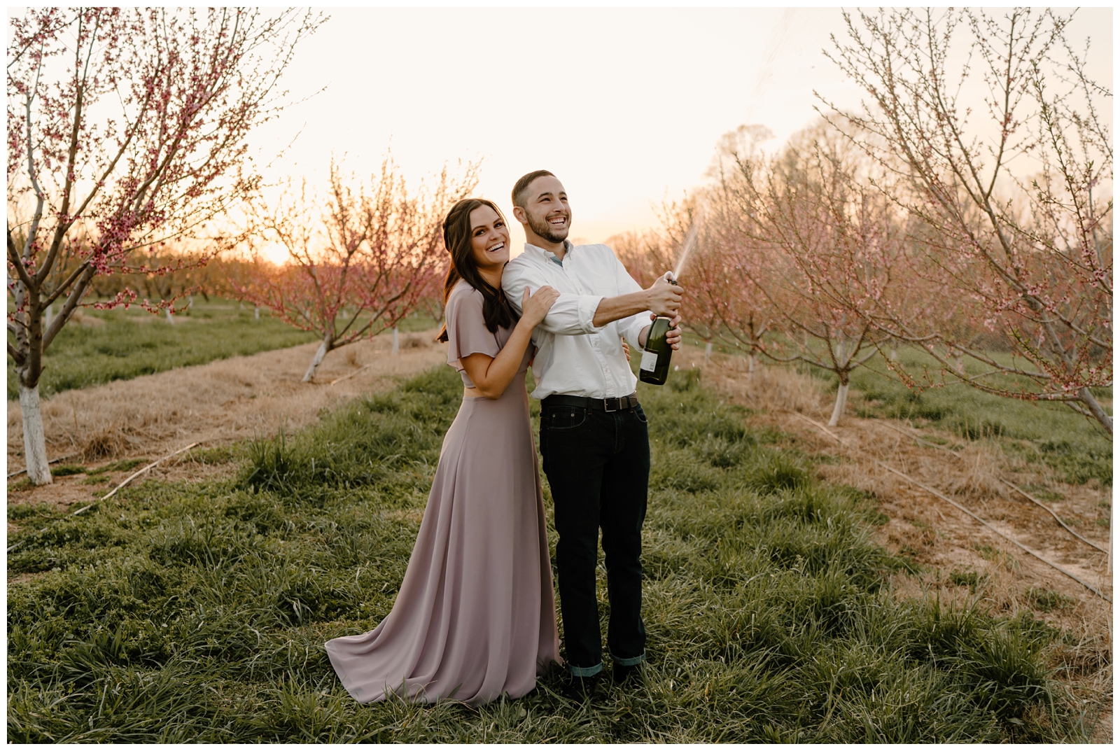 Popping champagne engagement photos in Greensboro, NC by North Carolina photographer