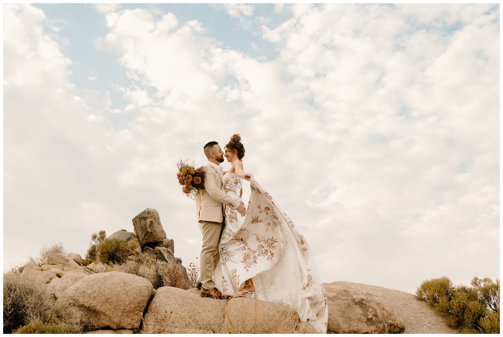 Bride's non traditional dress and bouquet for an indie chic elopement in Joshua Tree, adventurous couple portraits by destination wedding photographer
