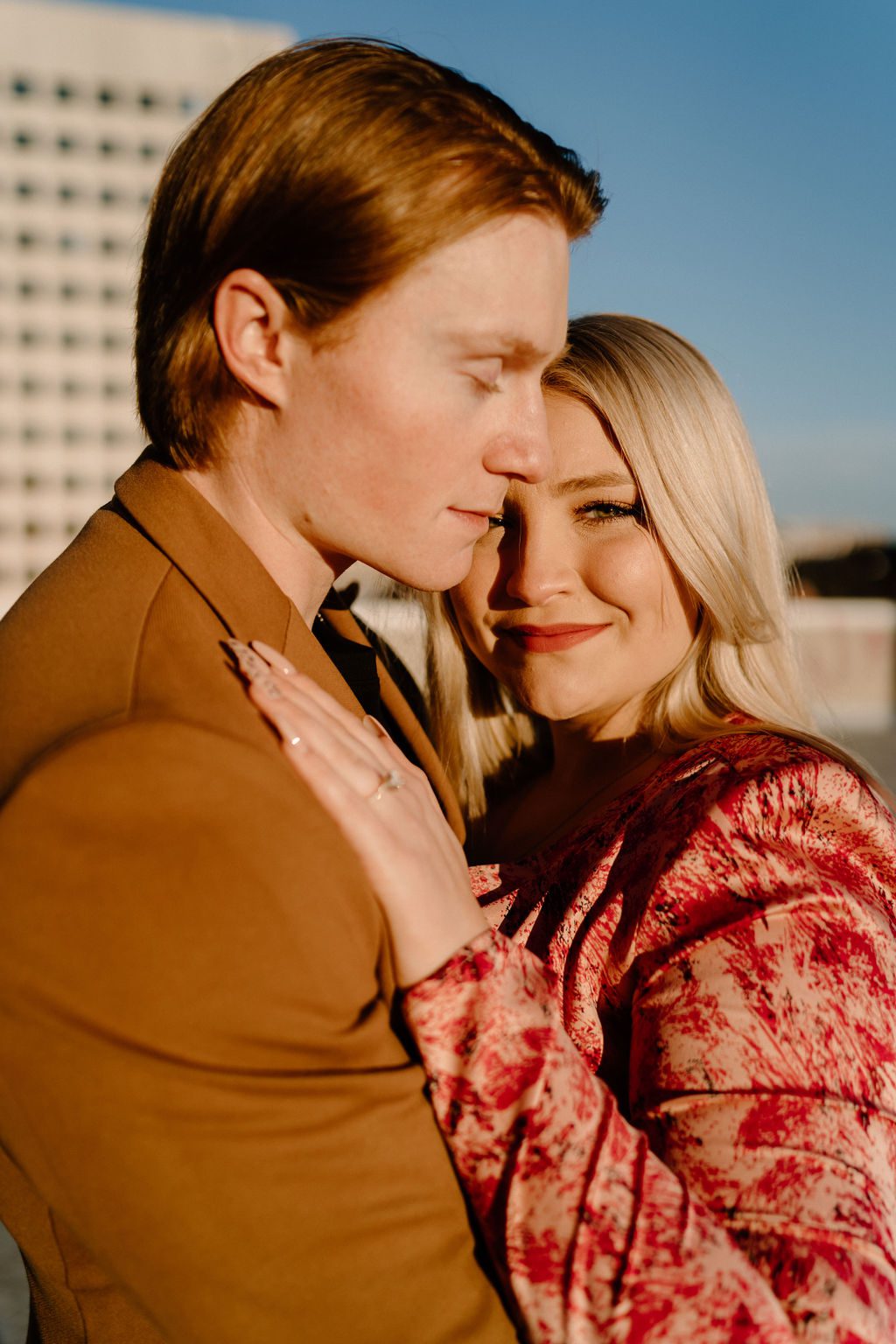 steamy engagement photos on rooftop of downtown north carolina