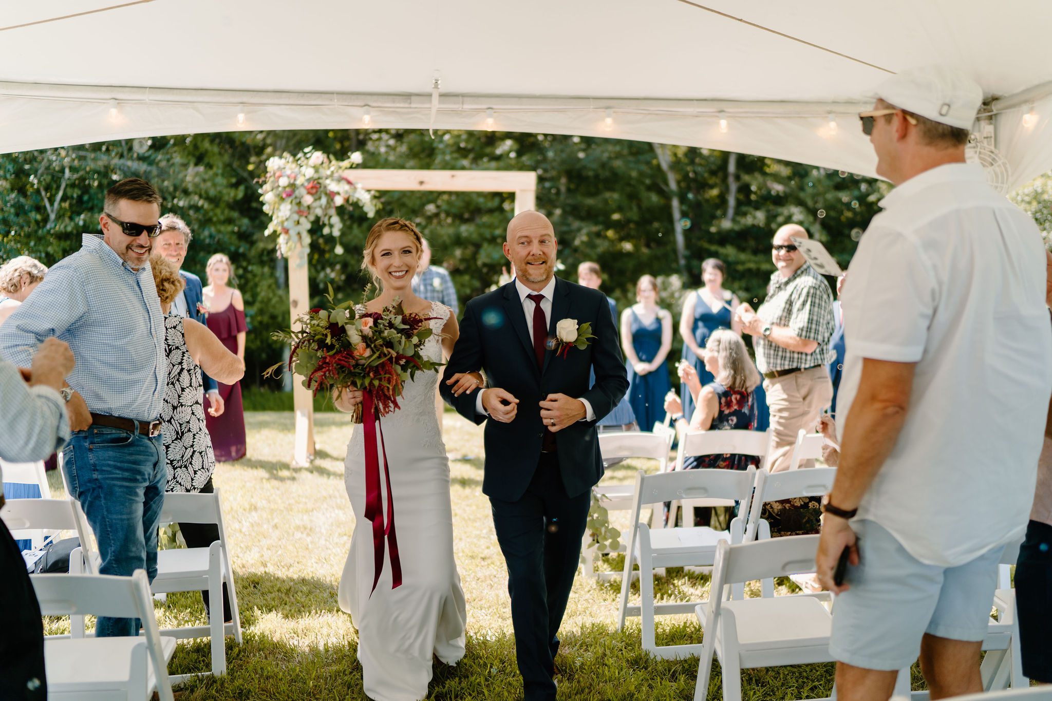 Beautiful bride and groom during their outdoor wedding day with fall themed wedding decor and unique wedding reception location