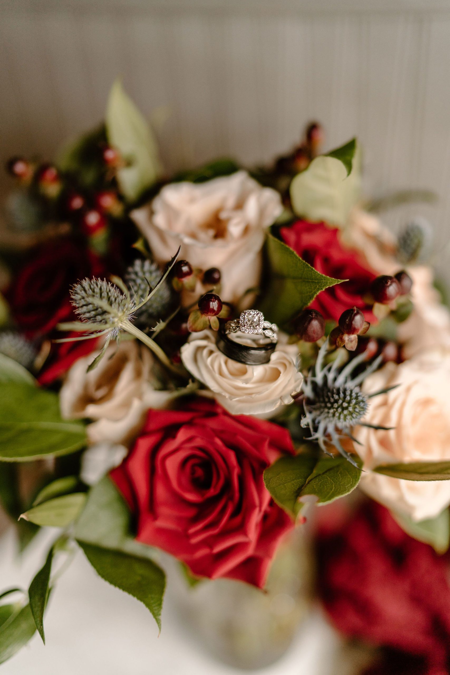 Bride and groom with Christmas themed flowers and decor and beautiful lace wedding dress in North Carolina
