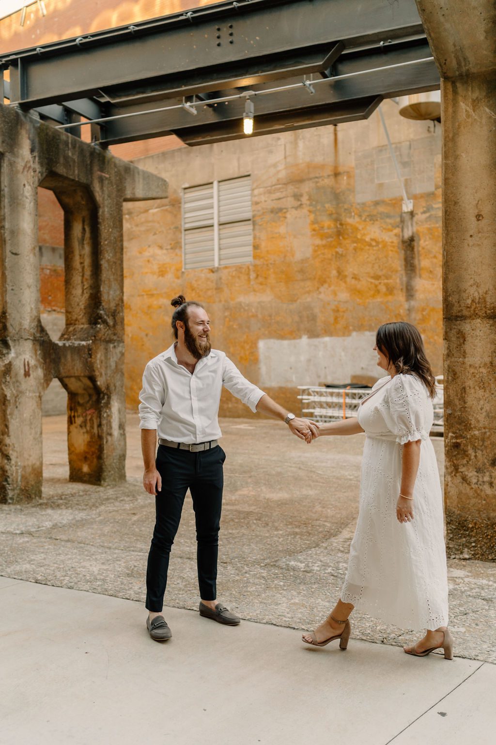 Couples photos during golden hour in North Carolina with gorgeous white dress at parking garage and downtown
