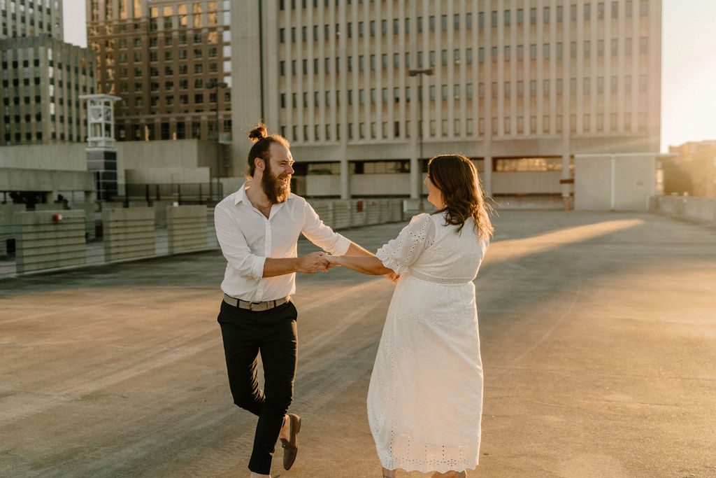 Couples photos during golden hour in North Carolina with gorgeous white dress at parking garage and downtown