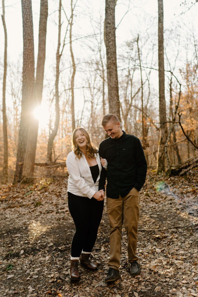 Couple posing for playful sunset engagement session in North Carolina
