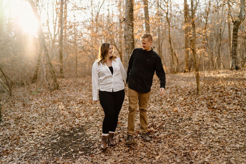 Couple posing for playful sunset engagement session in North Carolina