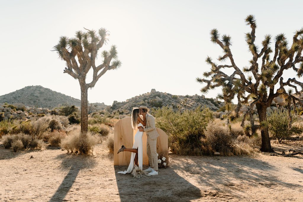 Couple posing for photos during destination Joshua Tree elopement in California 