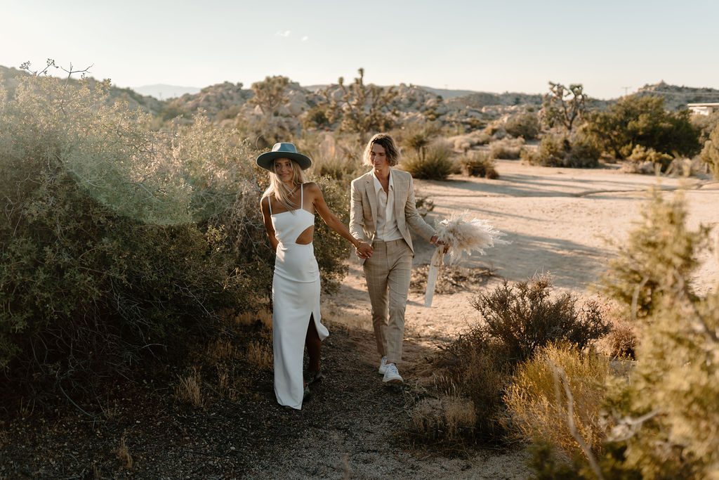 bride and groom walking around joshua tree california 