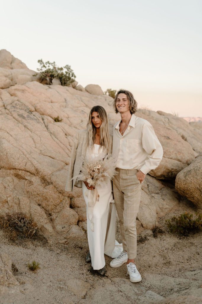 Couple posing for photos during destination Joshua Tree elopement in California 