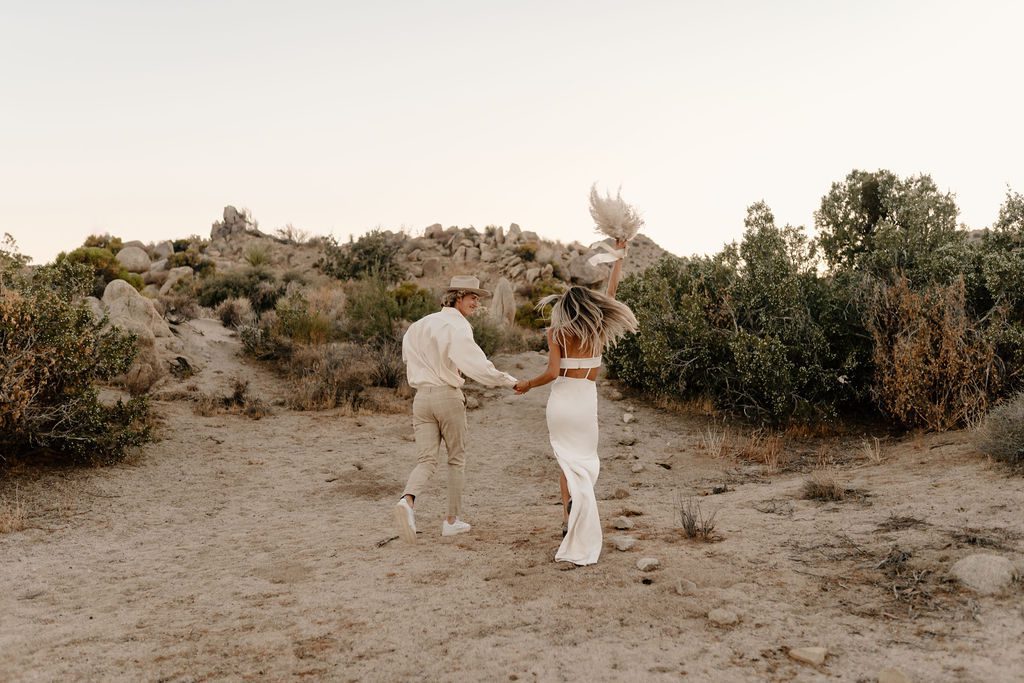couple running away from the camera for elopement photos
