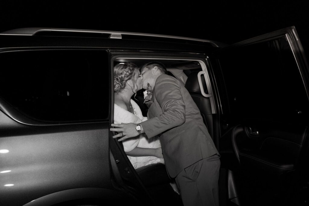 Bride and groom getting into getaway car