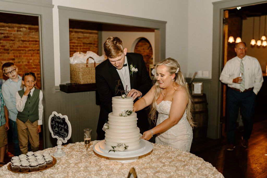 Bride and groom cutting the wedding cake
